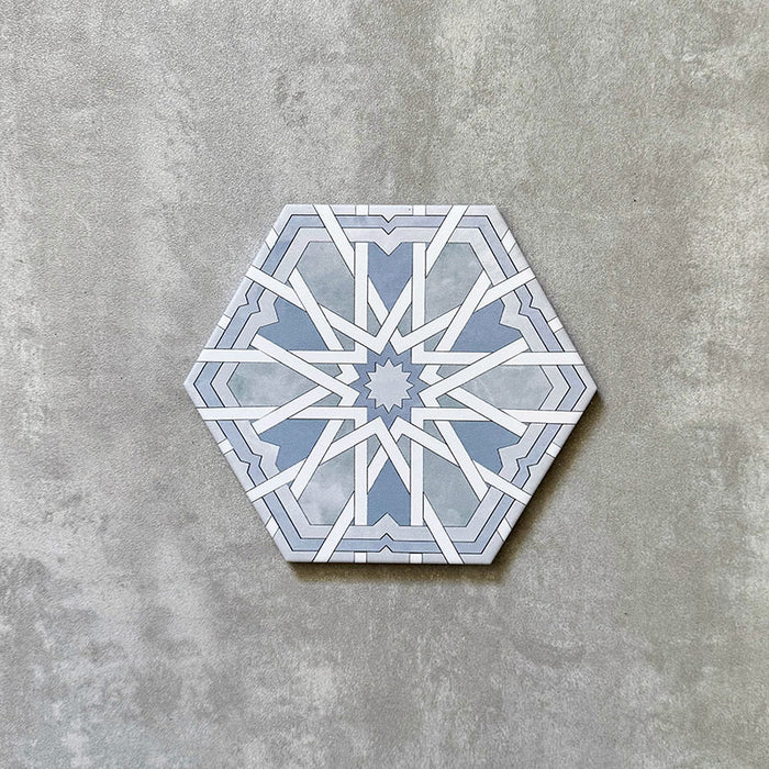Single Medina Hormuz Azure Blue Moroccan-style hexagon porcelain tile, 18.7 × 21.6 cm, featuring a bold star-inspired geometric pattern in soft blue and white tones on a neutral background.