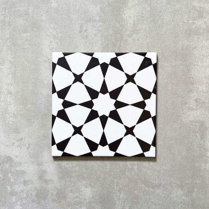 Agadir Black & White Moroccan-style 20x20cm porcelain tile featuring a bold geometric star pattern in black and white, shown as a single tile on a neutral background.