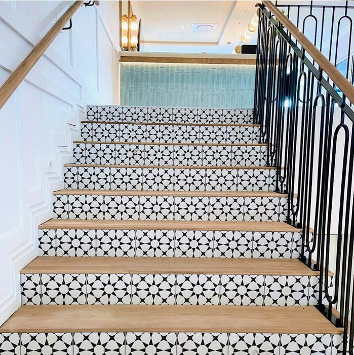 Staircase featuring Agadir Black & White Mini Moroccan-style 15x15cm porcelain tiles on the risers, showcasing a bold geometric star pattern, paired with natural wooden treads for a striking contrast.
