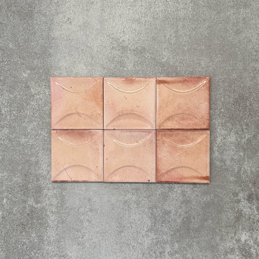Close-up of Saigon Rose Pink Decor Square Wall tiles, featuring Moroccan-style 10 × 10cm glossy ceramic tiles in soft blush and rose tones with a curved decorative relief pattern.