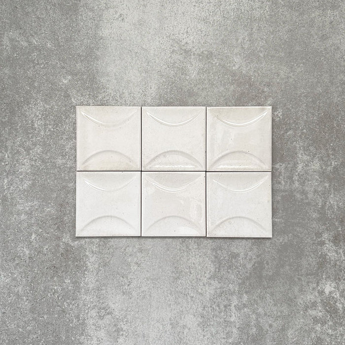 Saigon White Decor Square Wall tiles shown in a grouped layout, featuring Moroccan-style 10 × 10cm glossy ceramic tiles in soft white tones with a curved decorative relief pattern.
