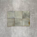 Close-up of Saigon Celadon Green Square Wall tiles in a Moroccan-inspired style, 10 × 10cm glossy ceramic tiles with soft green and blue-grey colour variation.