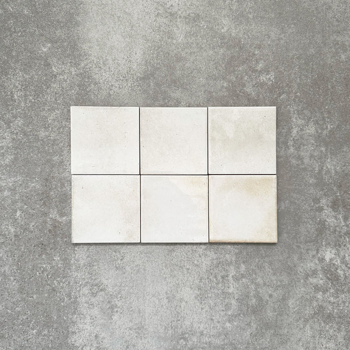 Close-up of Saigon White Square Wall tiles in a Moroccan-inspired style, 10 × 10cm glossy ceramic tiles in soft white tones with subtle tonal variation.