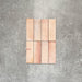 Close-up of Saigon Rose Pink Brick Wall tiles in a Moroccan-style design, 5.1 × 16.1cm glossy ceramic tiles with soft blush and rose colour variation, shown laid vertically.