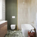 Almond Nut Matt 5x40 vertical wall tiles used in a bathroom, creating a calm, neutral backdrop with warm beige tones.