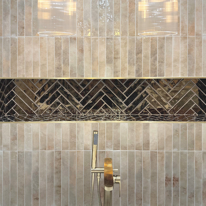 Vertical almond nut gloss wall tiles in a bathroom shower, featuring warm beige tones with a softly reflective, handcrafted-effect finish.