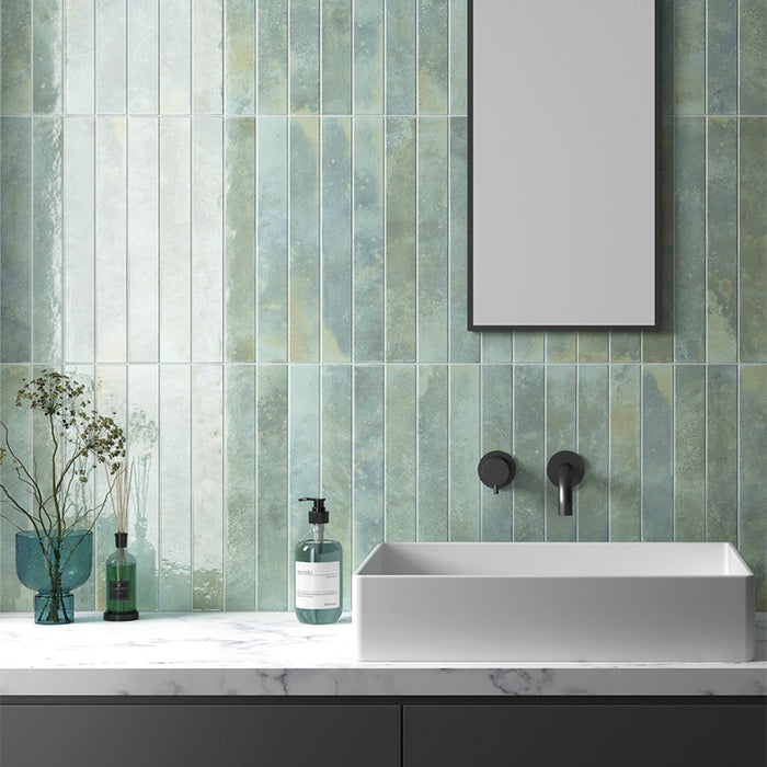 Jumairah Aqua Green 5x40cm vertical wall tiles in a bathroom setting, featuring soft blue-green tones with natural variation and a lightly textured finish.